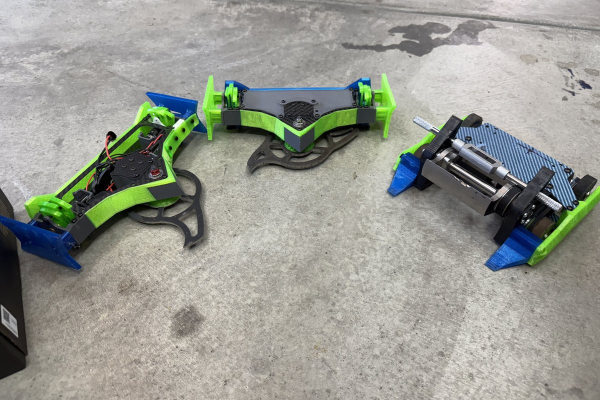 Three of the combat robots on a concrete floor