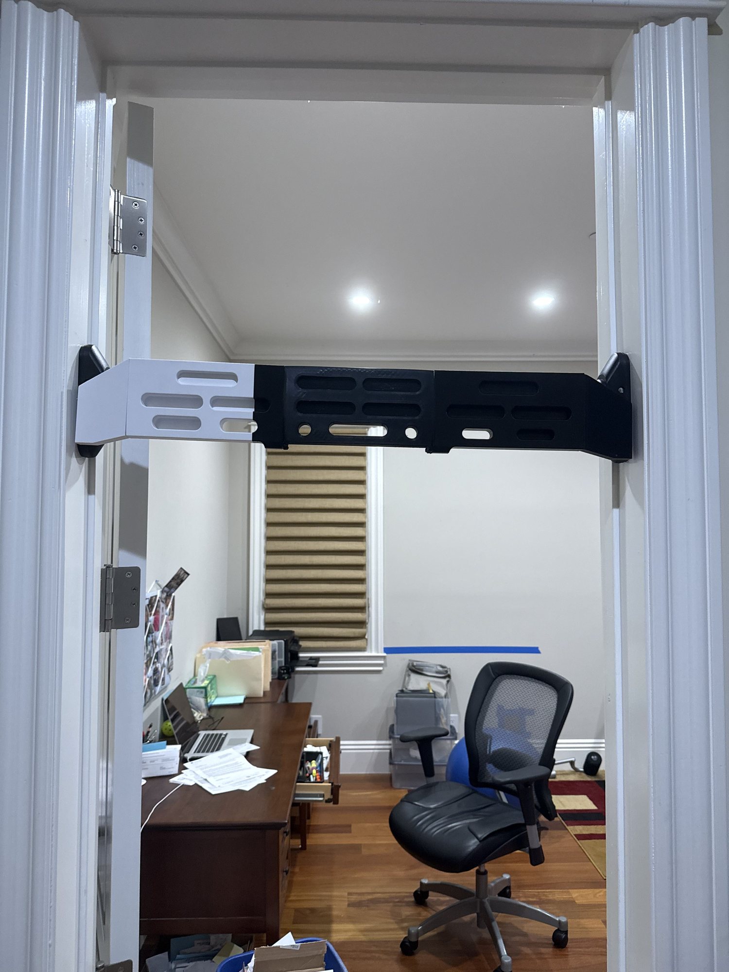 3D-printed climbing hangboard mounted across a doorframe