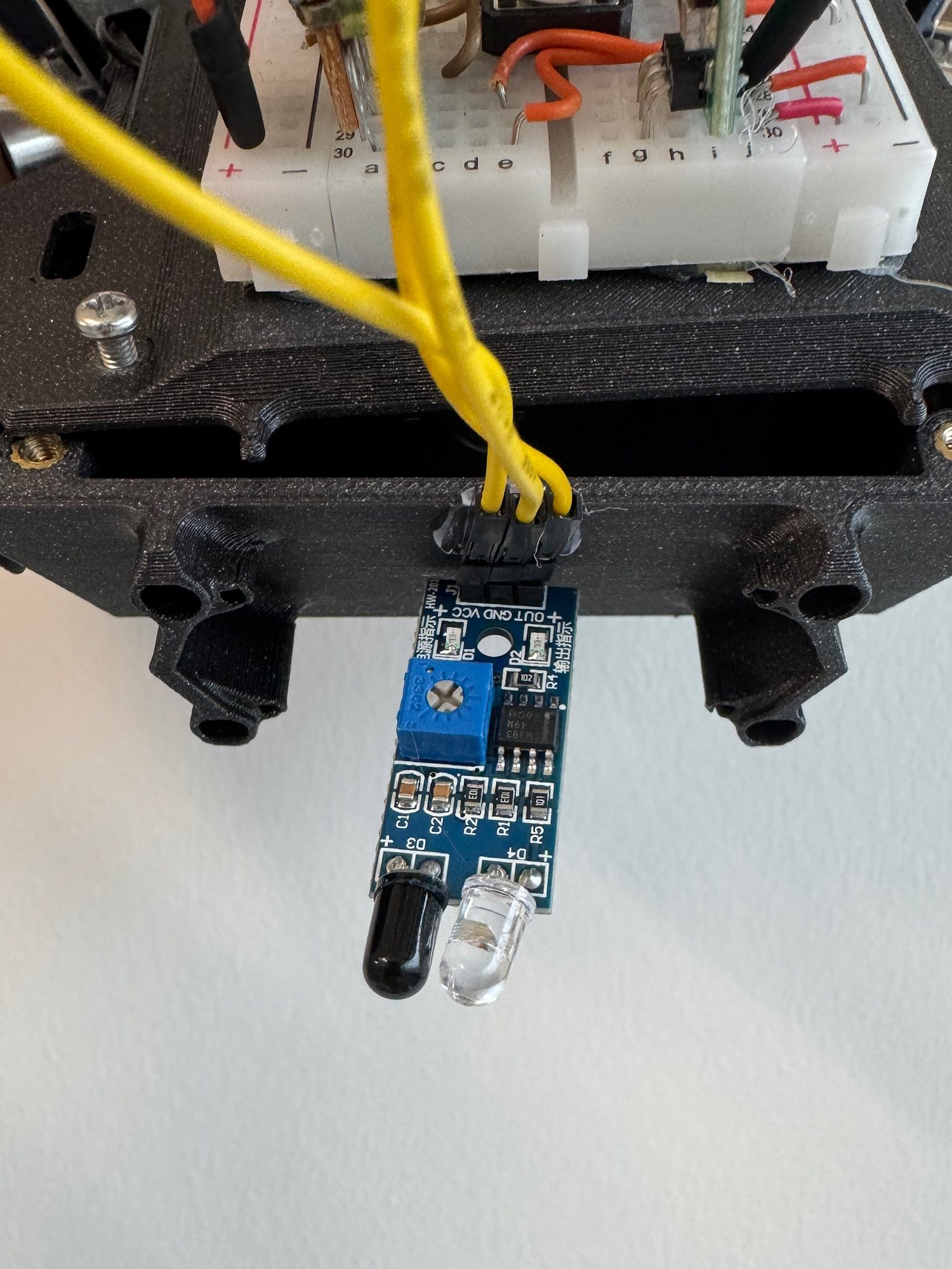 An IR sensor module mounted at the front edge of the printed chassis