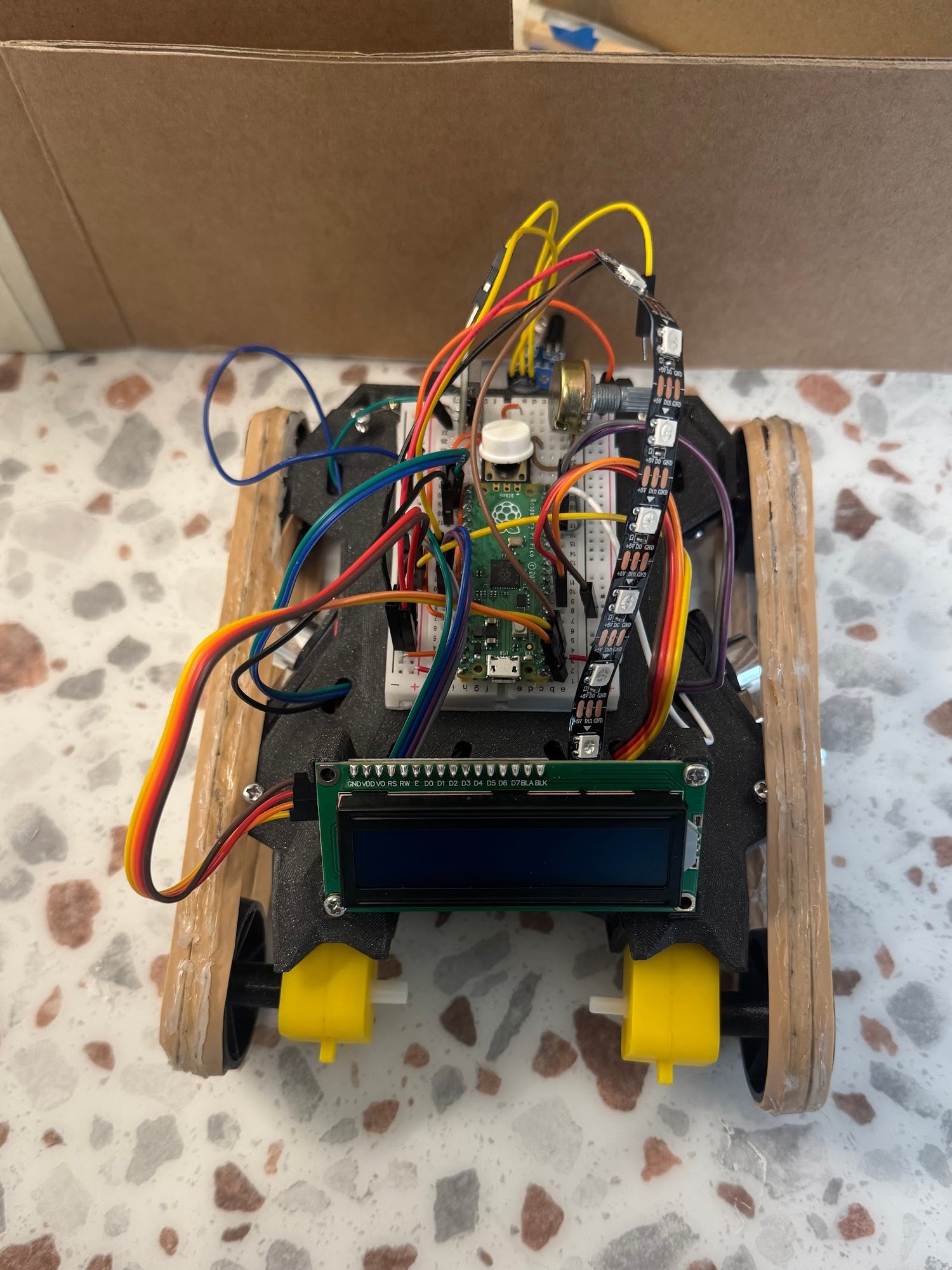 The robot stopped with its nose against a cardboard maze wall
