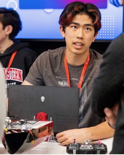 Talking visitors through V1 at the showcase, with a laptop and the RC transmitter on the table