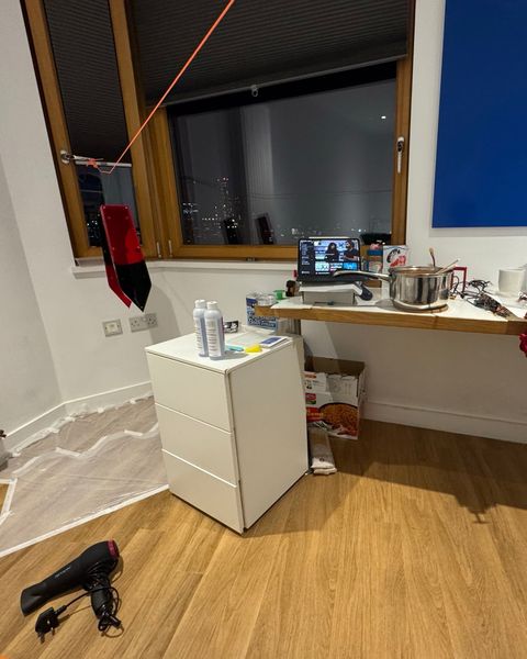 Our room in London set up as a workshop, with a hull section hanging over a taped-down drop sheet