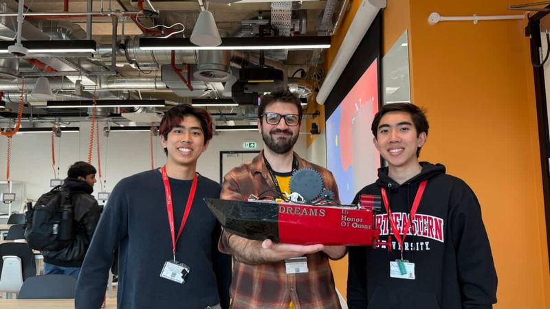 Kyle and Matthew with Omar, who is holding V1, at Northeastern University London